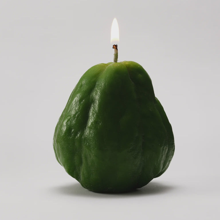 A green, lightly ridged surface, candle.